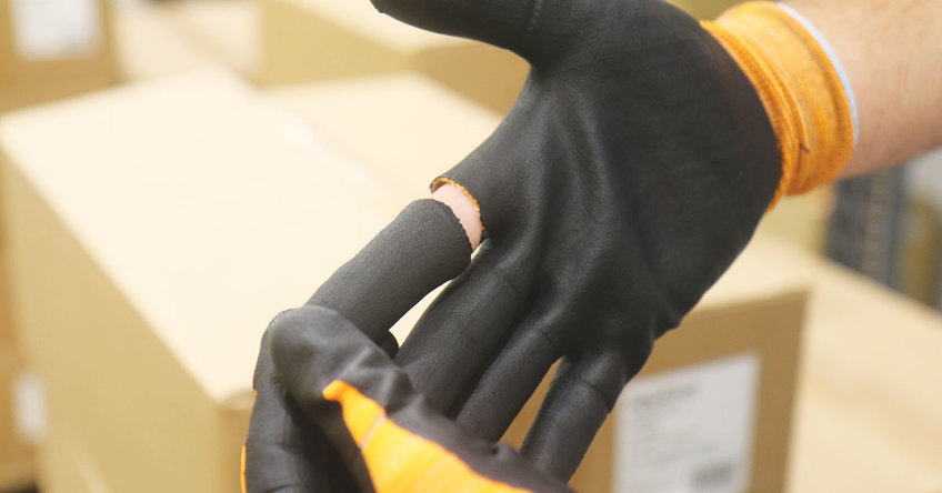 Hands wearing the Helix 1092 with safe finger release technology, showcasing how the tear away fingers work.