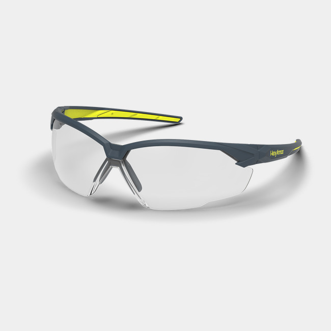 Grey and yellow NX1 anti-fog safety glasses shown as they are sitting on a table.