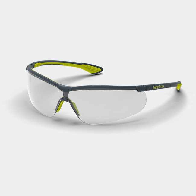 Grey and yellow VS250 anti-fog safety glasses shown as they are sitting on a table.