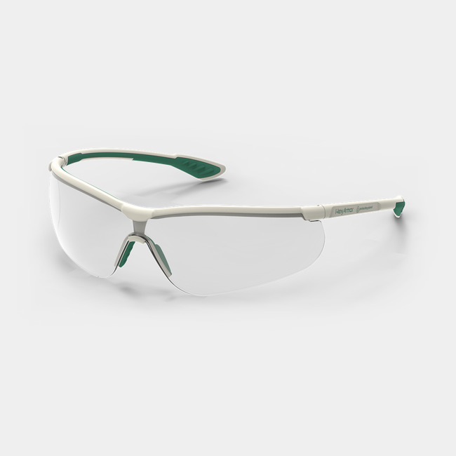 Green and white VS250 planet series sustainable anti-fog safety glasses shown as they are sitting on a table.