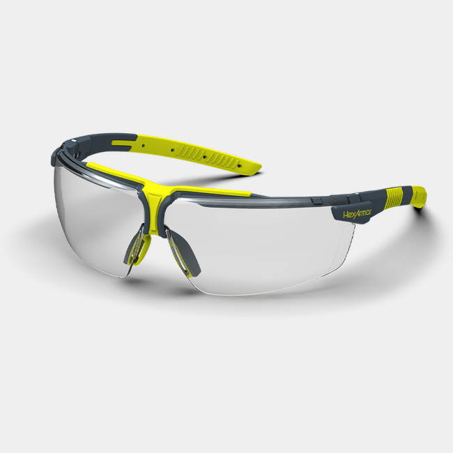 Grey and yellow VS300 anti-fog safety glasses shown as they are sitting on a table.