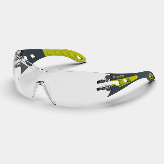 Grey and yellow MX200 anti-fog safety glasses shown as they are sitting on a table.