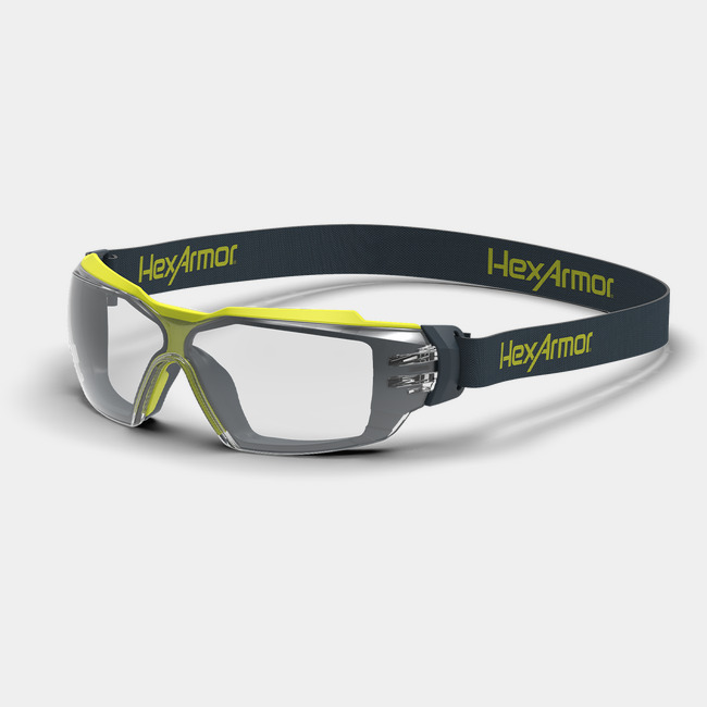Grey and yellow MX350 anti-fog safety glasses with head strap shown as they are sitting on a table.