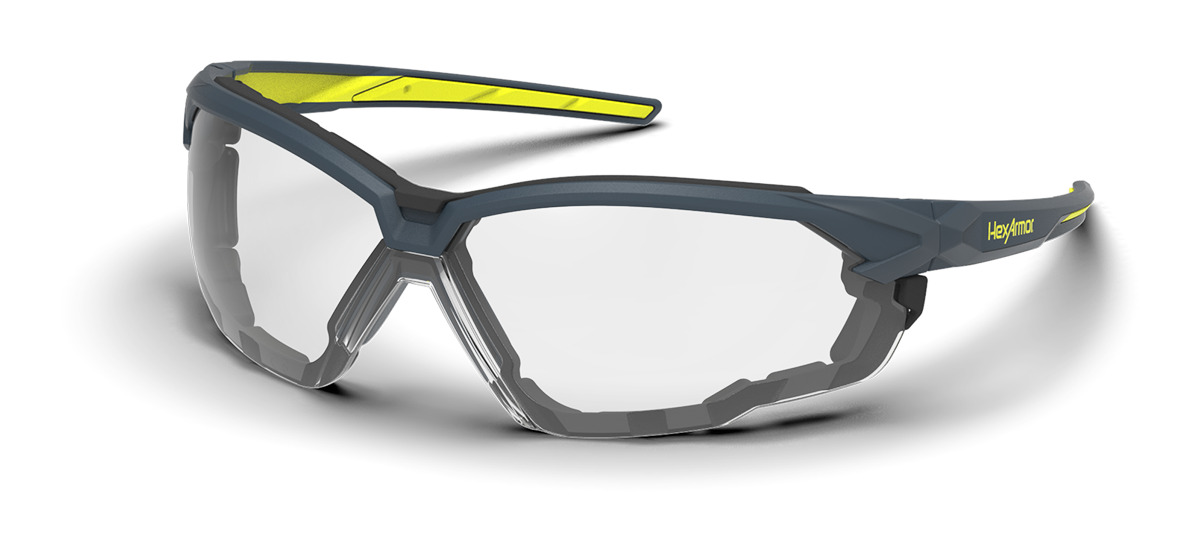Grey and yellow NX1G anti-fog gasketed safety glasses shown as they are sitting on a table.